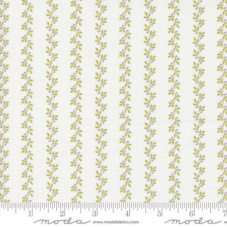 a white and green striped fabric with leaves on it