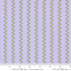 a purple and green striped fabric with leaves on it