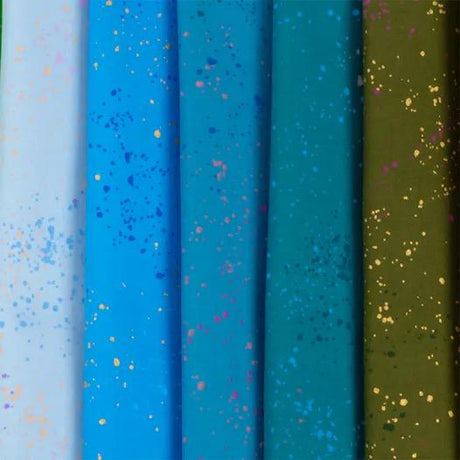 a row of different colored papers with gold and blue sprinkles