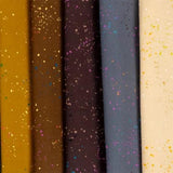 a row of different colors of paper with sprinkles