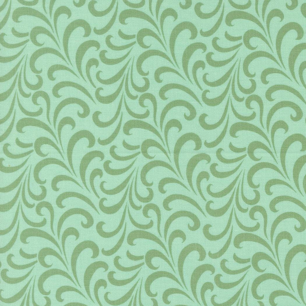 a green and white wallpaper with swirls on it