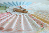 a close up of many different colored papers