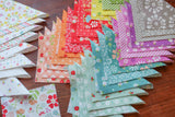 a table topped with lots of different colored paper