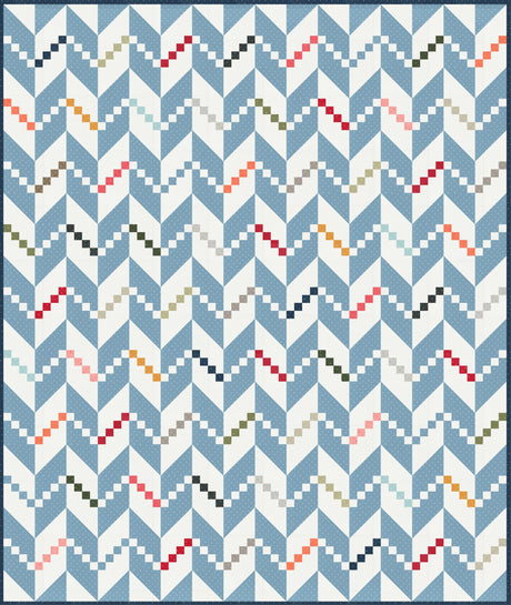 a blue and white quilt with a pattern on it