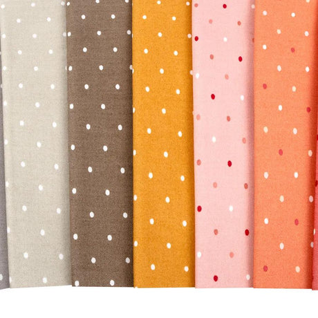 a row of different colored polka dot fabric