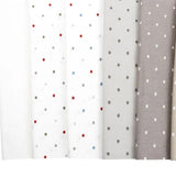 a row of different colored polka dot curtains