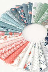 a circle of different colored fabrics on a white surface