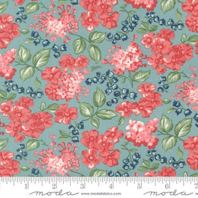a blue and red flowered fabric with green leaves