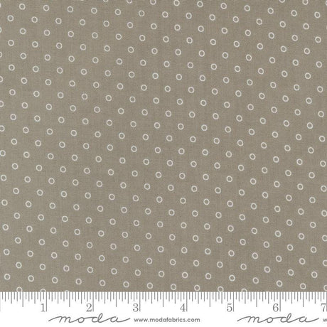 a ruler with a brown background with white circles