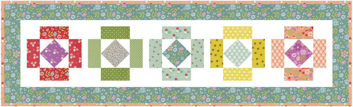 a quilted wall hanging with different colored blocks