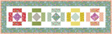 a quilted wall hanging with different colored blocks