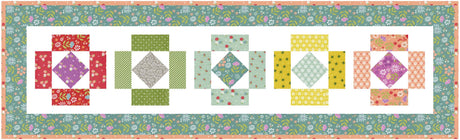 a quilted wall hanging with different colored blocks