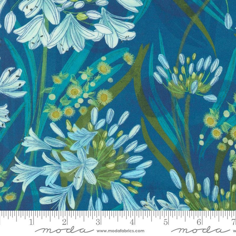 a blue background with white flowers and green leaves