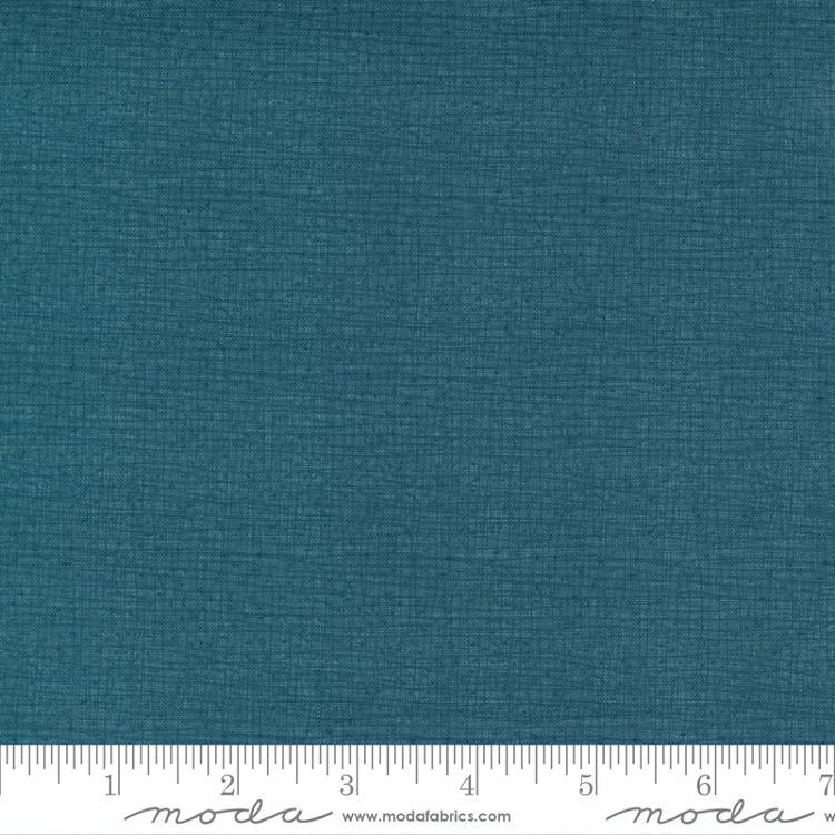 a blue fabric with a ruler in front of it