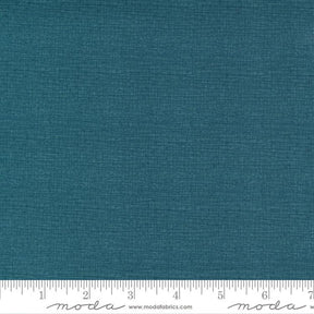 a blue fabric with a ruler in front of it