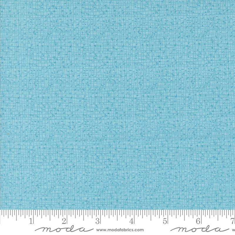 a ruler with a blue fabric on it