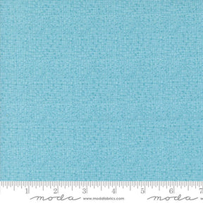 a ruler with a blue fabric on it