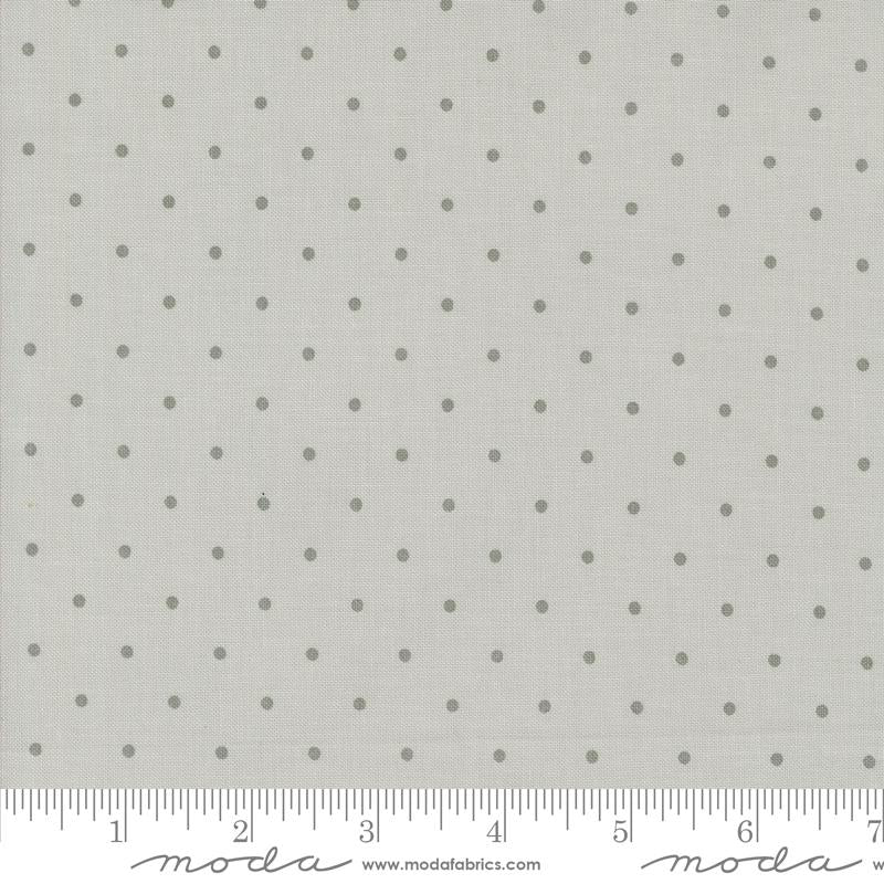 a ruler with a white background with gray polka dots
