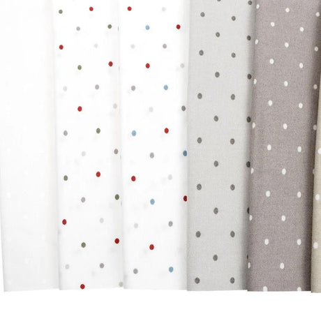 a row of different colored polka dot curtains