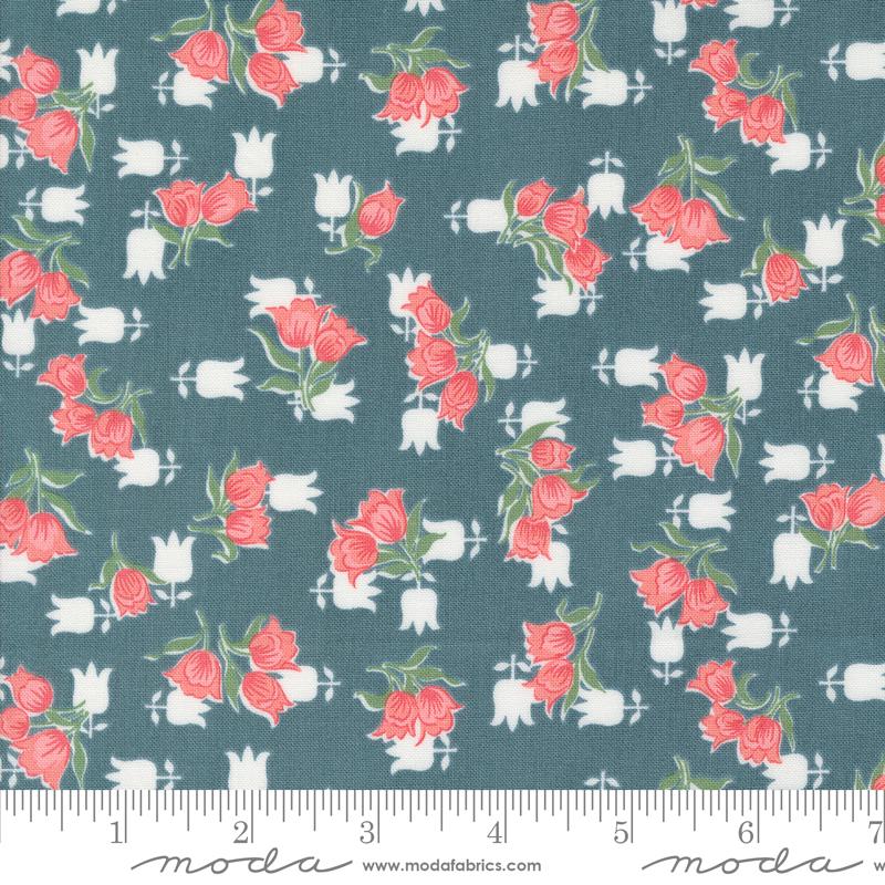 a blue fabric with pink roses on it