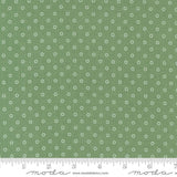 a ruler with a green background with white circles