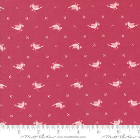 a red fabric with white birds on it