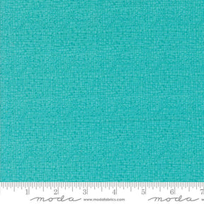 a ruler with a blue fabric on it