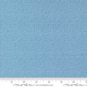 a blue fabric with a ruler in front of it