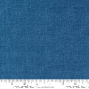 a blue fabric with a ruler in front of it