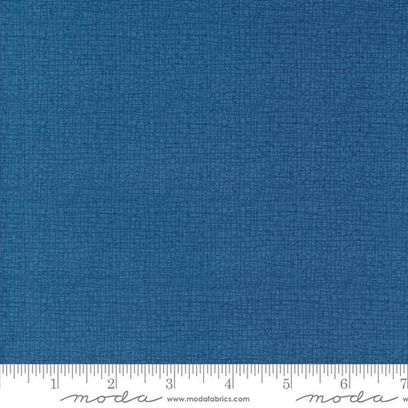 a blue fabric with a ruler in front of it
