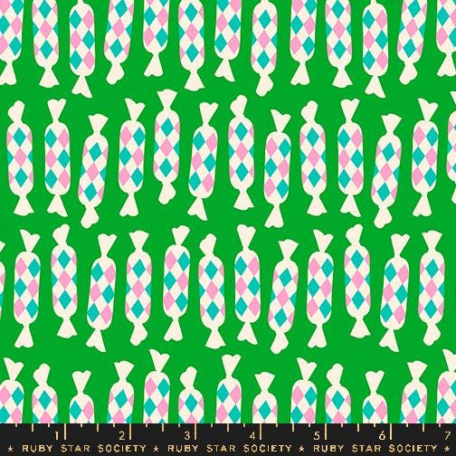 a green background with pink, blue, and white geometric shapes