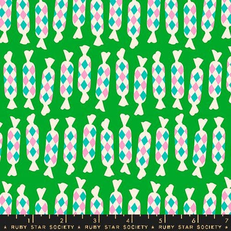 a green background with pink, blue, and white geometric shapes
