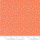 an orange and white polka dot print fabric