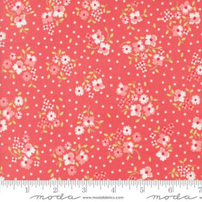 a red fabric with white and pink flowers on it