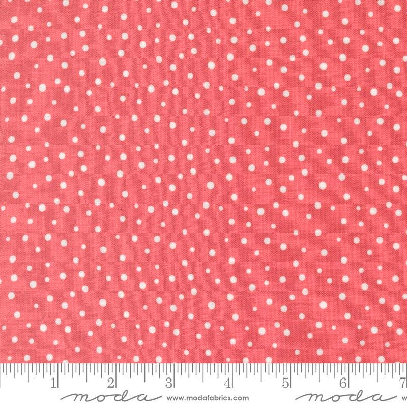 a ruler with a red background with white polka dots