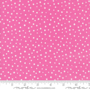 a pink background with white polka dots