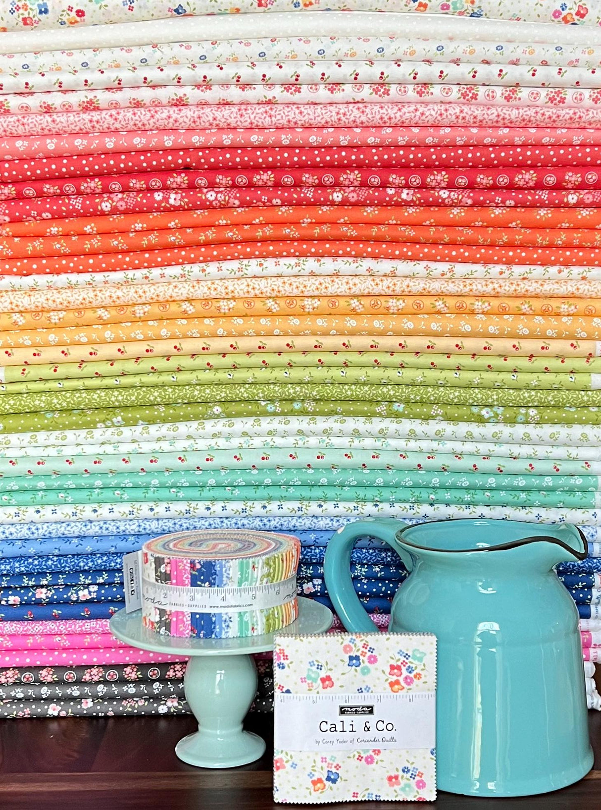 a blue pitcher sitting on top of a wooden table