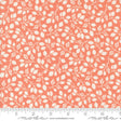 an orange and white fabric with leaves on it