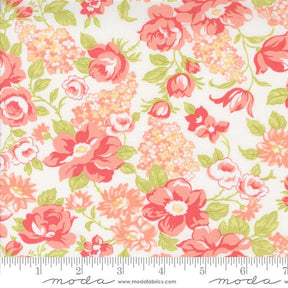 a white and pink flowered fabric with green leaves