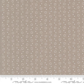a ruler with a brown background with white dots