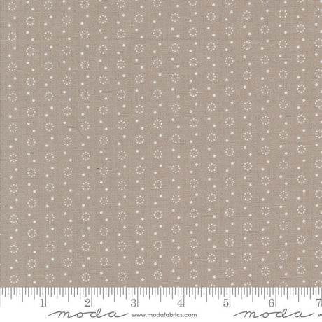 a ruler with a brown background with white dots