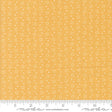 a yellow fabric with white dots on it
