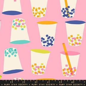 a pink background with cups and a ruler