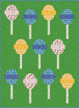 a quilted picture of lollipops on a green background
