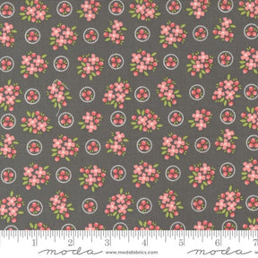 a gray background with pink flowers and circles