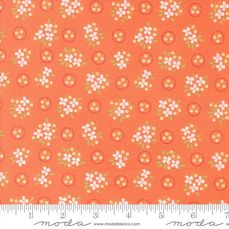 an orange fabric with white flowers on it