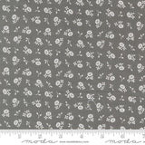a gray fabric with white flowers on it