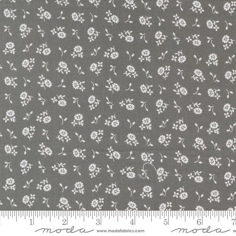 a gray fabric with white flowers on it