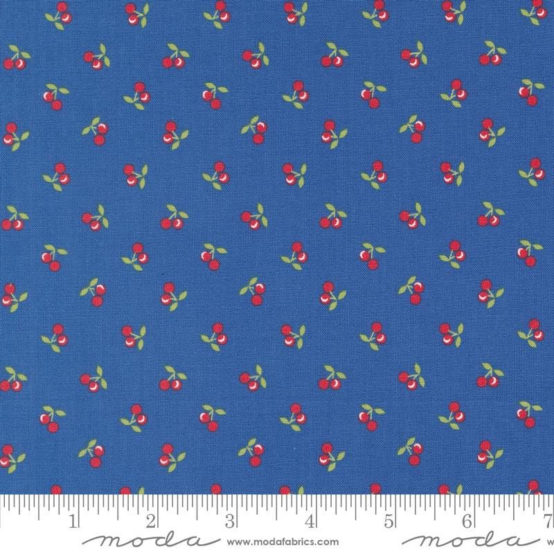 a blue background with red cherries and green leaves