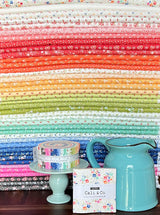 a blue pitcher sitting on top of a wooden table